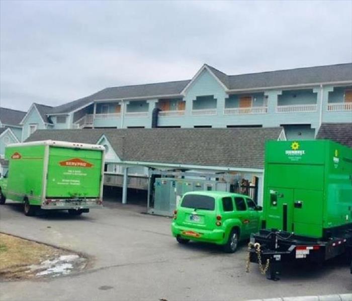 This photograph is of an apartment complex that suffered a fife loo with SERVPRO vehicles responding. 