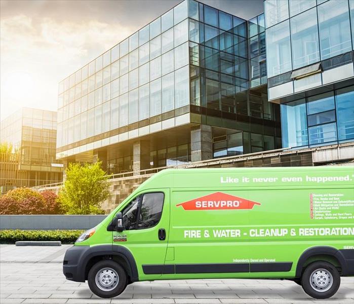This picture shows a SERVPRO van outside of a commercial office building.